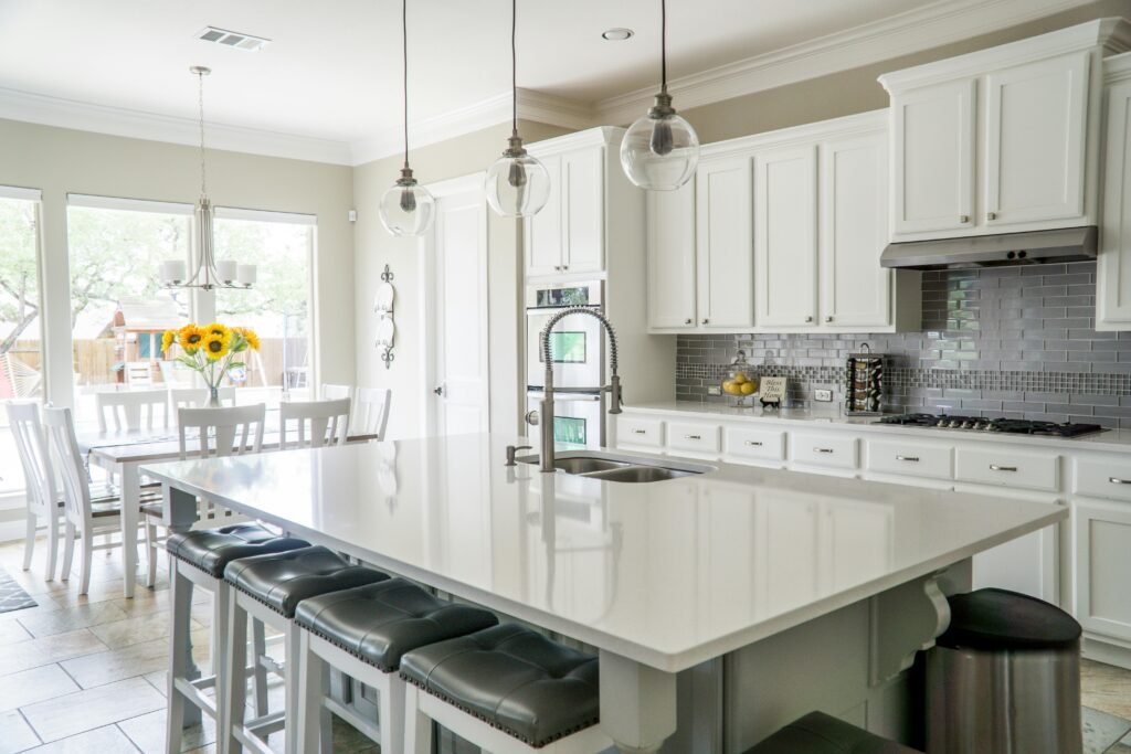 Home Spacious modern kitchen with white cabinets and island in natural light.